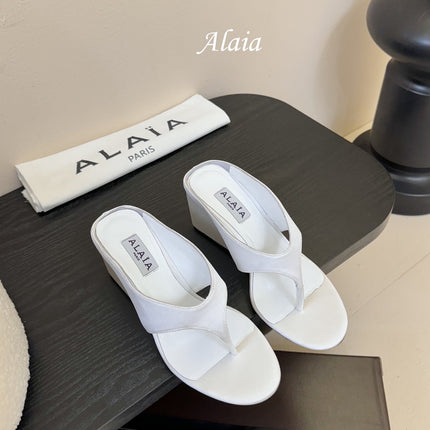 ALAIA WEDGE THONG SANDALS 25S IN WHITE SATIN