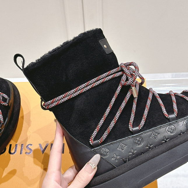 ASPEN PLATFORM ANKLE BOOT IN BLACK MONOGRAM DEBOSSED SUEDE AND SHEARLING