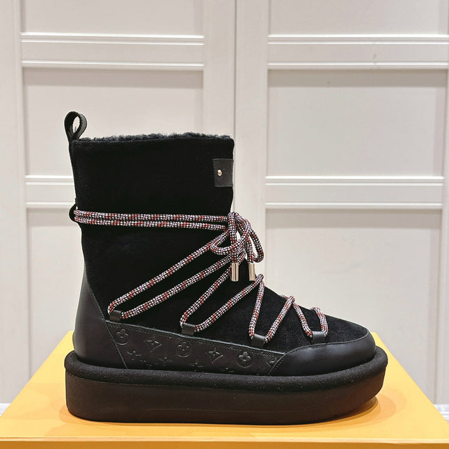 ASPEN PLATFORM ANKLE BOOT IN BLACK MONOGRAM DEBOSSED SUEDE AND SHEARLING