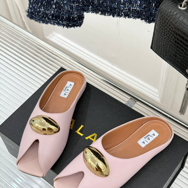 ALAIA FLAT MULE IN LIGHT PINK LAMBSKIN WITH GOLD HARDWARE