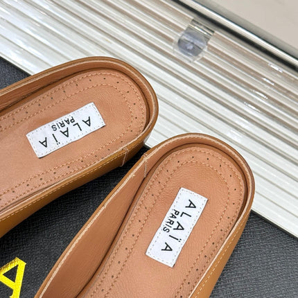 ALAIA FLAT MULE IN BRONZE BROWN LAMBSKIN WITH GOLD HARDWARE