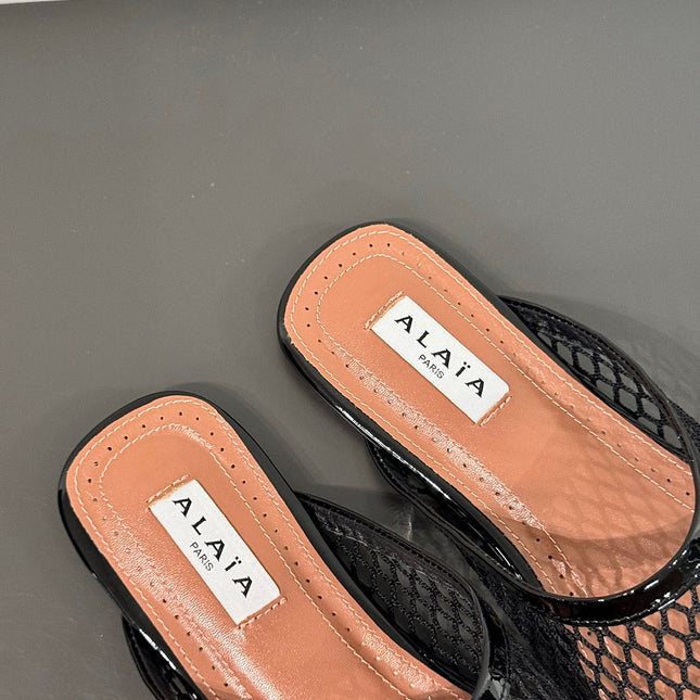 ALAIA FLAT MULES IN BLACK MESH FISHNET