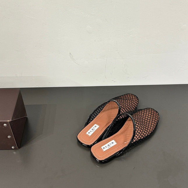 ALAIA FLAT MULES IN BLACK MESH FISHNET