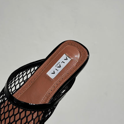 ALAIA FLAT MULES IN BLACK MESH FISHNET