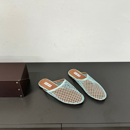 ALAIA FLAT MULES IN LIGHT BLUE MESH FISHNET