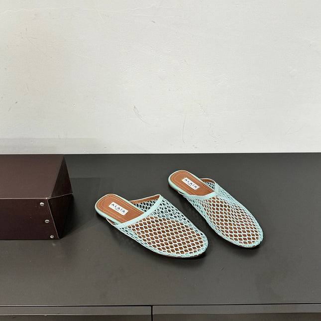 ALAIA FLAT MULES IN LIGHT BLUE MESH FISHNET