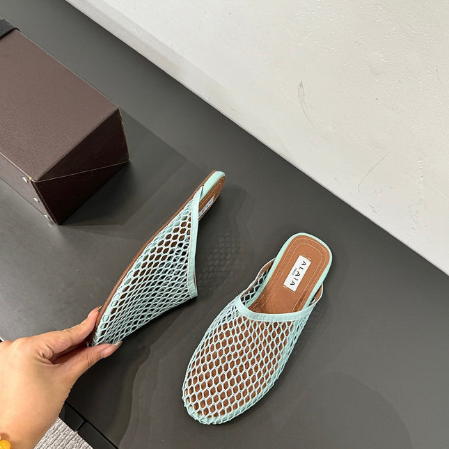ALAIA FLAT MULES IN LIGHT BLUE MESH FISHNET