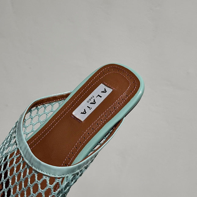 ALAIA FLAT MULES IN LIGHT BLUE MESH FISHNET