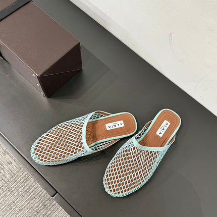 ALAIA FLAT MULES IN LIGHT BLUE MESH FISHNET