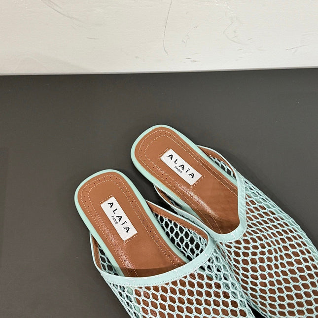 ALAIA FLAT MULES IN LIGHT BLUE MESH FISHNET