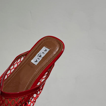 ALAIA FLAT MULES IN CHERRY RED MESH FISHNET