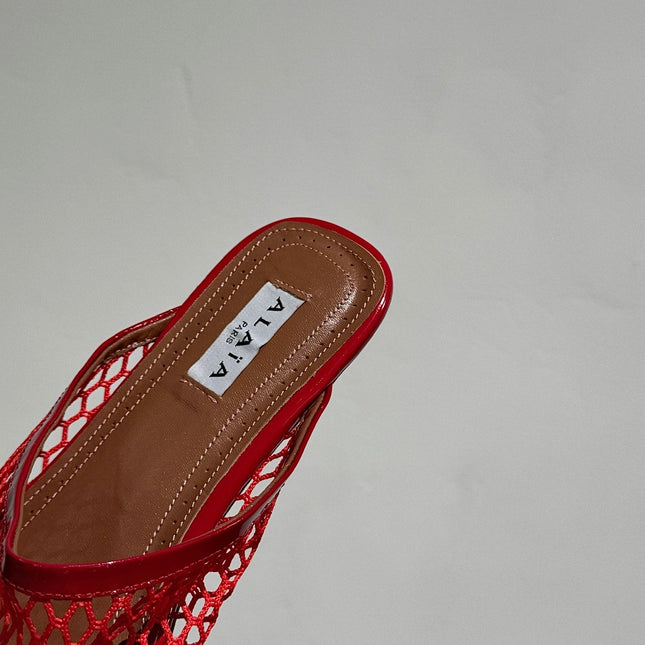 ALAIA FLAT MULES IN CHERRY RED MESH FISHNET