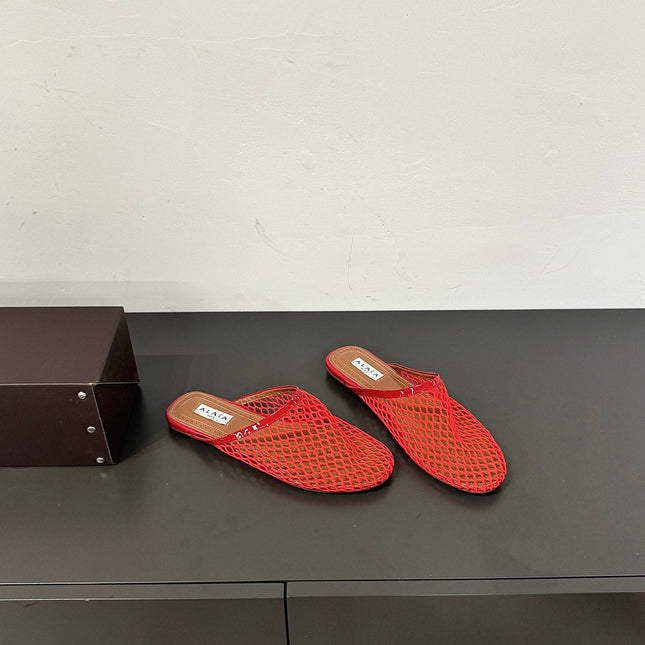 ALAIA FLAT MULES IN CHERRY RED MESH FISHNET