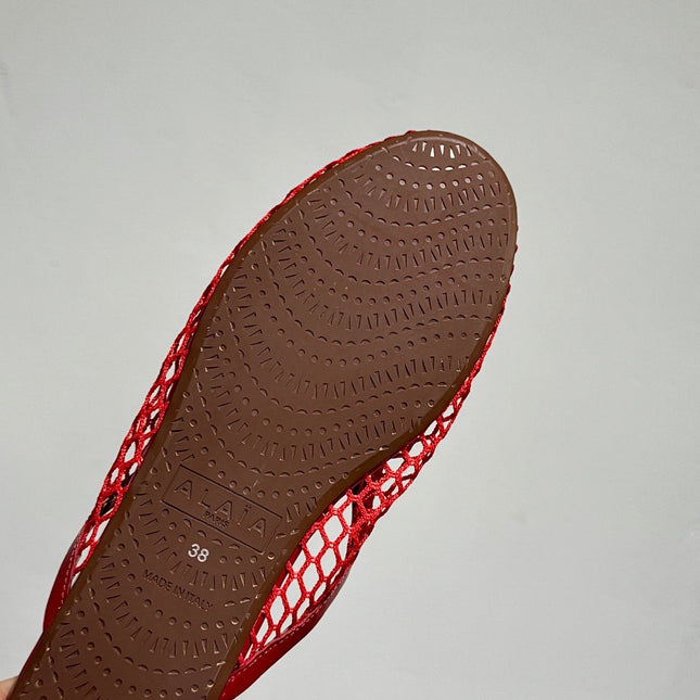 ALAIA FLAT MULES IN CHERRY RED MESH FISHNET