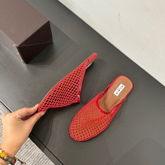 ALAIA FLAT MULES IN CHERRY RED MESH FISHNET