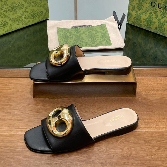 FLAT MULE IN BLACK CALFSKIN WITH GOLD HARDWARE