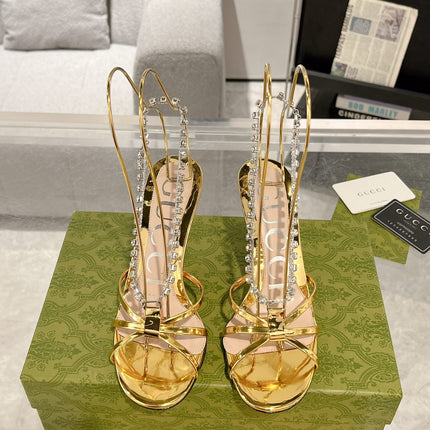 STRAPPY SANDAL WITH RHINESTONE CHAIN IN GOLD PATENT LEATHER