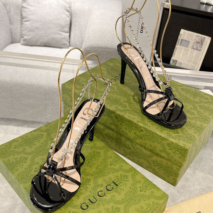 STRAPPY SANDAL WITH RHINESTONE CHAIN IN BLACK PATENT LEATHER