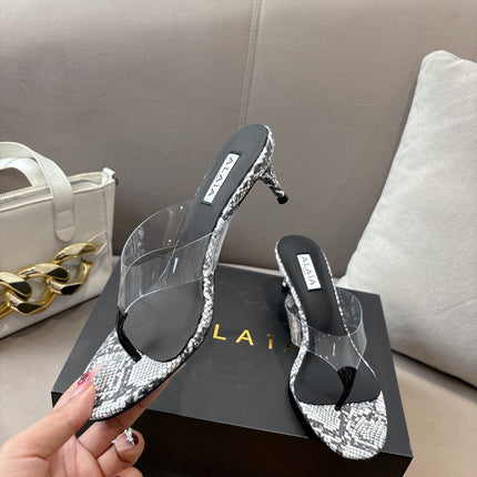 ALAIA HEELED THONG 25S 55 MM IN WHITE AND BLACK LAMBSKIN SNAKE-EMBOSSED WITH CLEAR STRAP