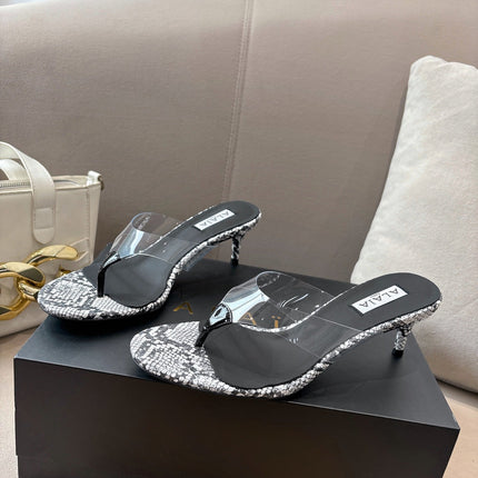 ALAIA HEELED THONG 25S 55 MM IN WHITE AND BLACK LAMBSKIN SNAKE-EMBOSSED WITH CLEAR STRAP