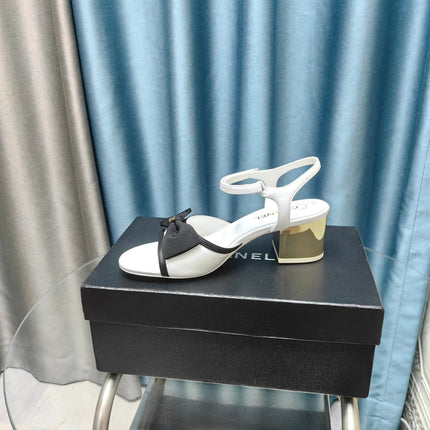 SANDALS IN WHITE SHEEPSKIN WITH BLACK SATIN BOW