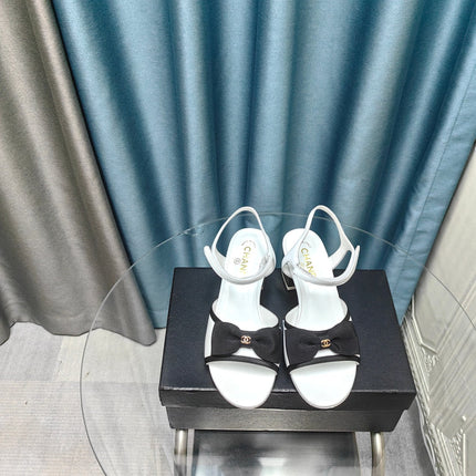 SANDALS IN WHITE SHEEPSKIN WITH BLACK SATIN BOW