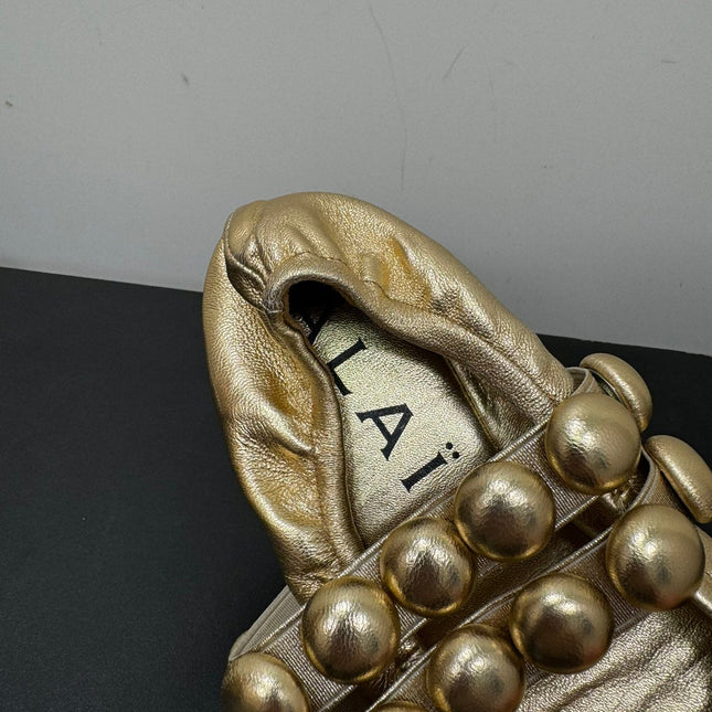 ALAIA SPHERE BALLET FLATS IN GOLDEN LAMBSKIN