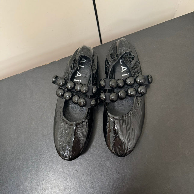ALAIA SPHERE BALLET FLATS IN BLACK LAMBSKIN