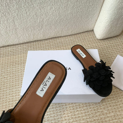 ALAIA FLAT MULE IN BLACK SUEDE
