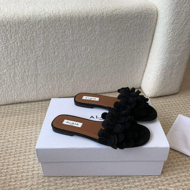 ALAIA FLAT MULE IN BLACK SUEDE