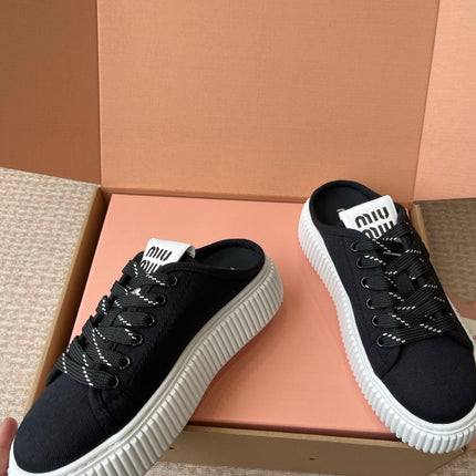WASH SNEAKER MULES IN BLACK DENIM