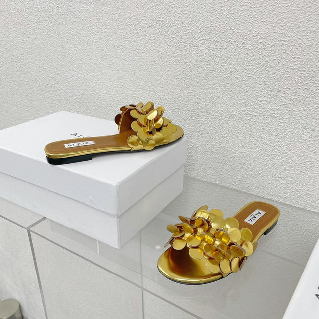 ALAIA FLAT MULE IN GOLDEN GLOSSY LAMBSKIN