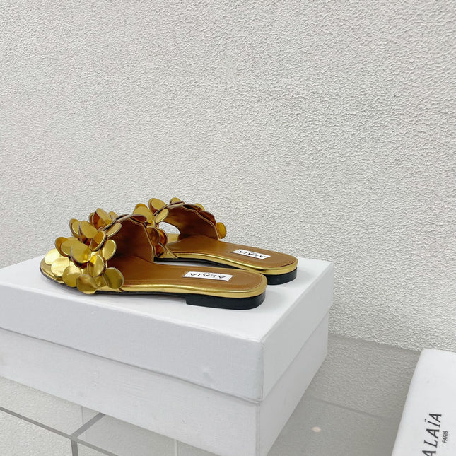ALAIA FLAT MULE IN GOLDEN GLOSSY LAMBSKIN