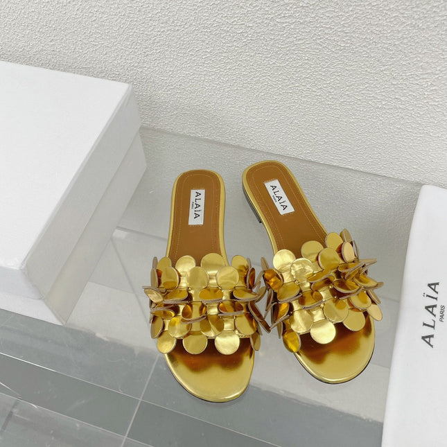 ALAIA FLAT MULE IN GOLDEN GLOSSY LAMBSKIN