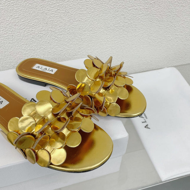ALAIA FLAT MULE IN GOLDEN GLOSSY LAMBSKIN
