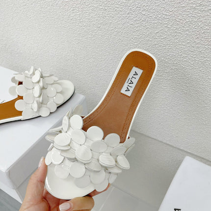ALAIA FLAT MULE IN WHITE GLOSSY LAMBSKIN