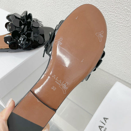 ALAIA FLAT MULE IN BLACK GLOSSY LAMBSKIN