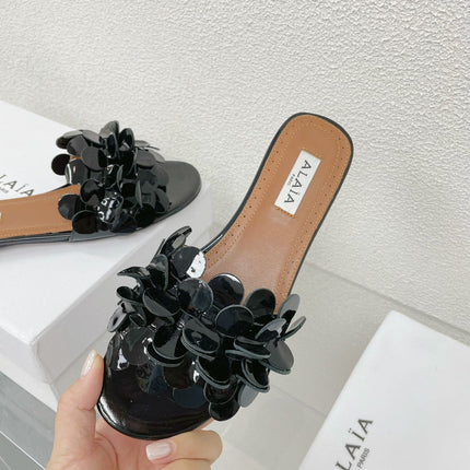 ALAIA FLAT MULE IN BLACK GLOSSY LAMBSKIN