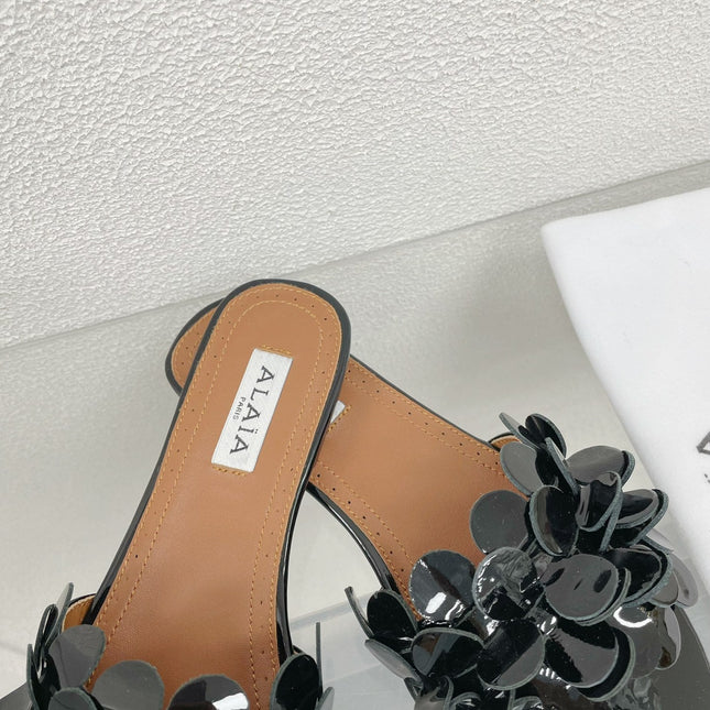 ALAIA FLAT MULE IN BLACK GLOSSY LAMBSKIN