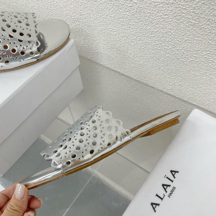 ALAIA VIENNE FLAT MULES IN SILVER LAMBSKIN