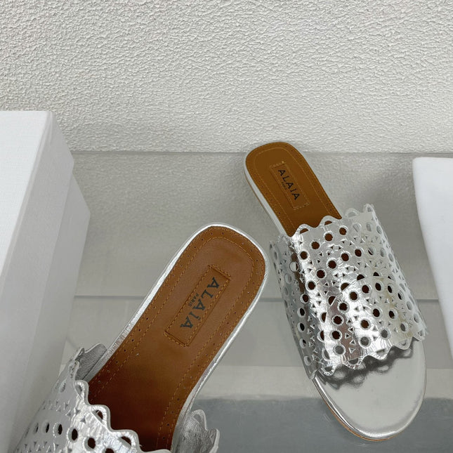 ALAIA VIENNE FLAT MULES IN SILVER LAMBSKIN
