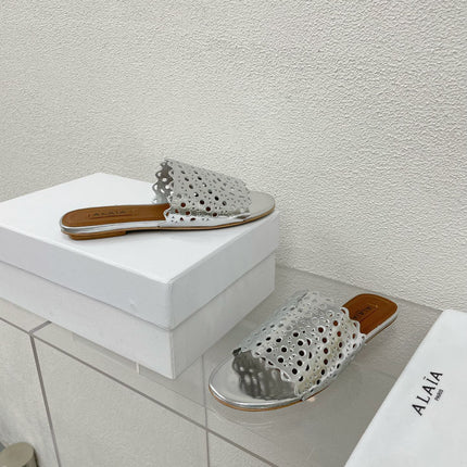 ALAIA VIENNE FLAT MULES IN SILVER LAMBSKIN
