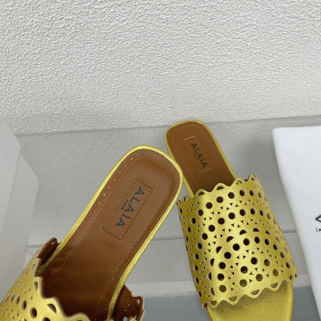 ALAIA VIENNE FLAT MULES IN GOLDEN LAMBSKIN