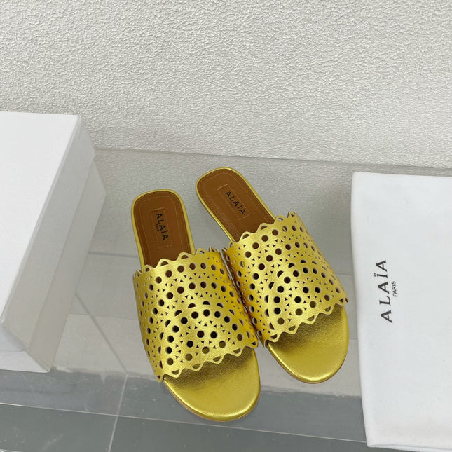ALAIA VIENNE FLAT MULES IN GOLDEN LAMBSKIN