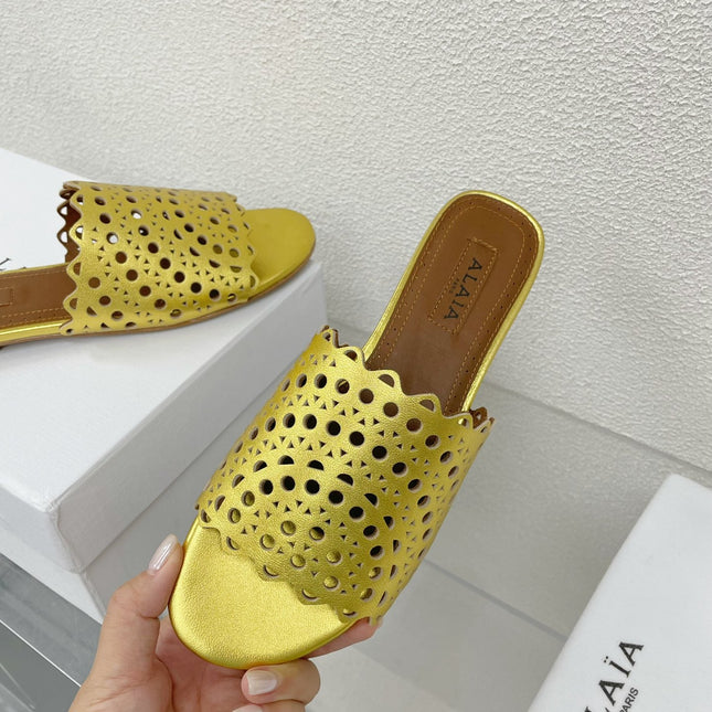 ALAIA VIENNE FLAT MULES IN GOLDEN LAMBSKIN