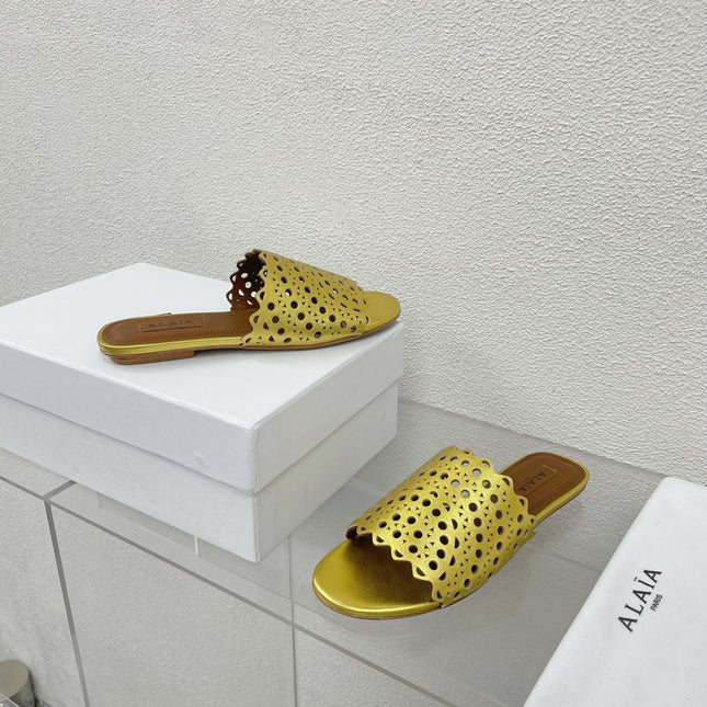 ALAIA VIENNE FLAT MULES IN GOLDEN LAMBSKIN
