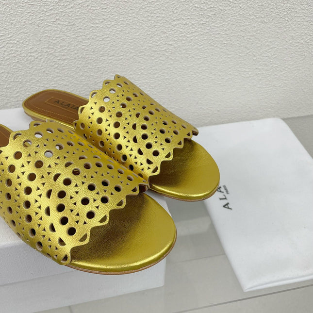 ALAIA VIENNE FLAT MULES IN GOLDEN LAMBSKIN