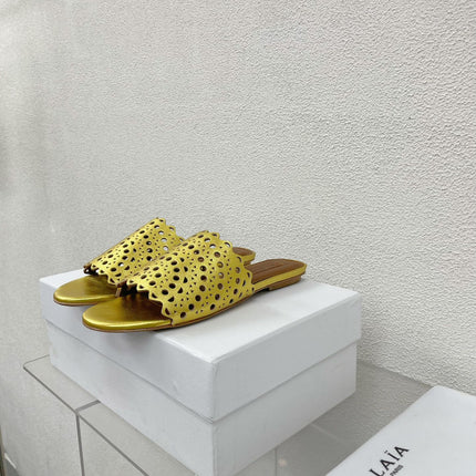 ALAIA VIENNE FLAT MULES IN GOLDEN LAMBSKIN