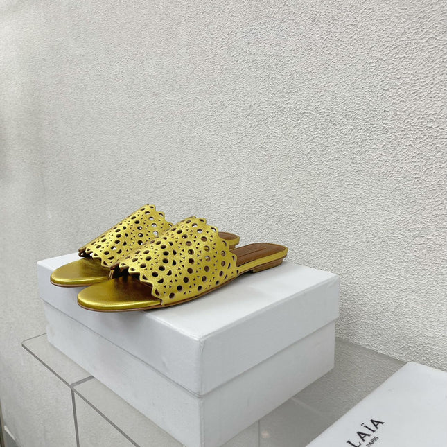 ALAIA VIENNE FLAT MULES IN GOLDEN LAMBSKIN