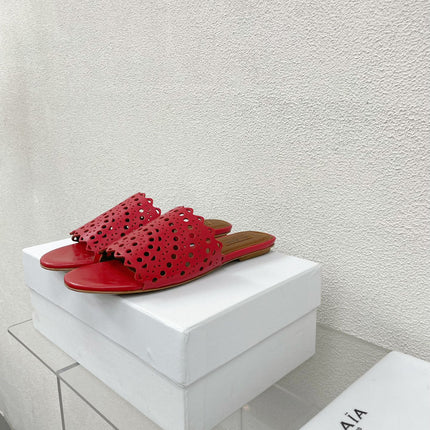 ALAIA VIENNE FLAT MULES IN CHERRY RED LAMBSKIN